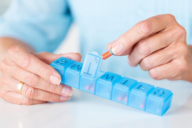 man sorting pills